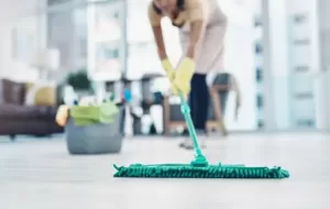 Professional cleaner mopping floor during spring cleaning service in Singapore