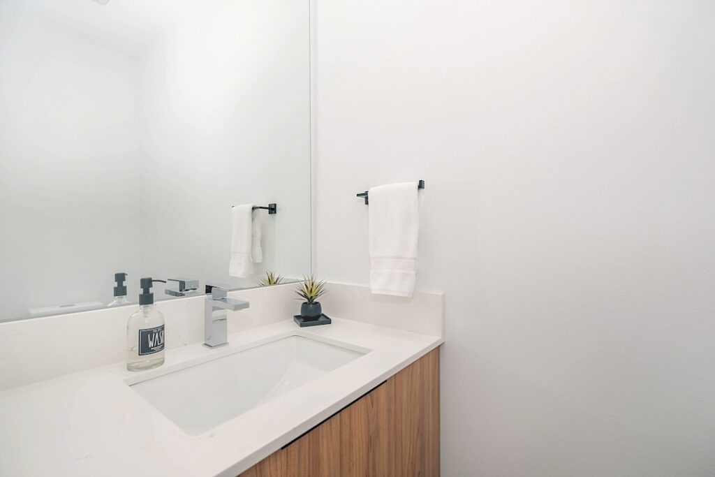 Clean Modern bathroom sink with mirror and towel