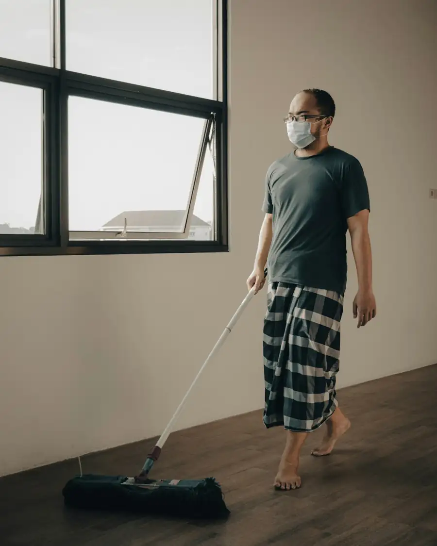 Man mopping wooden floor in Singapore home