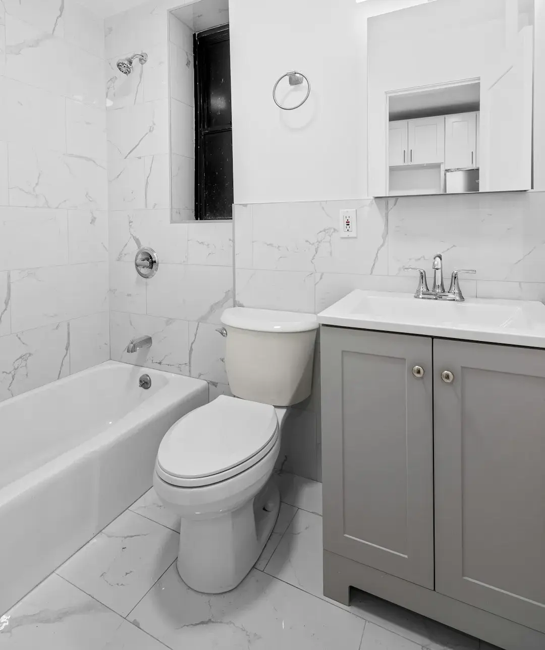 Modern bathroom with bathtub, toilet, and vanity