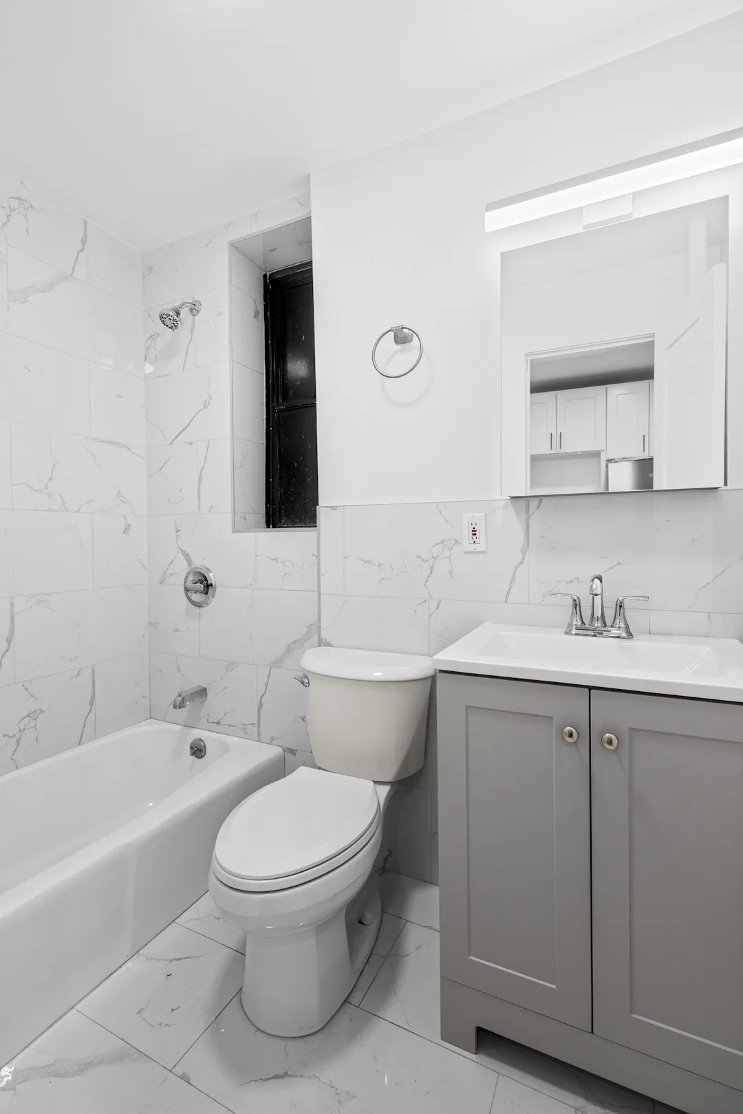 Modern bathroom with bathtub, toilet, and vanity