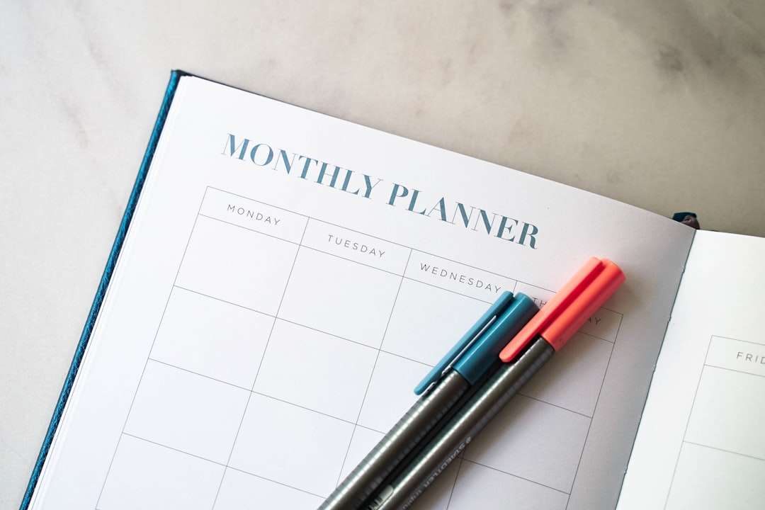 Monthly cleaning schedule planner with colorful pens