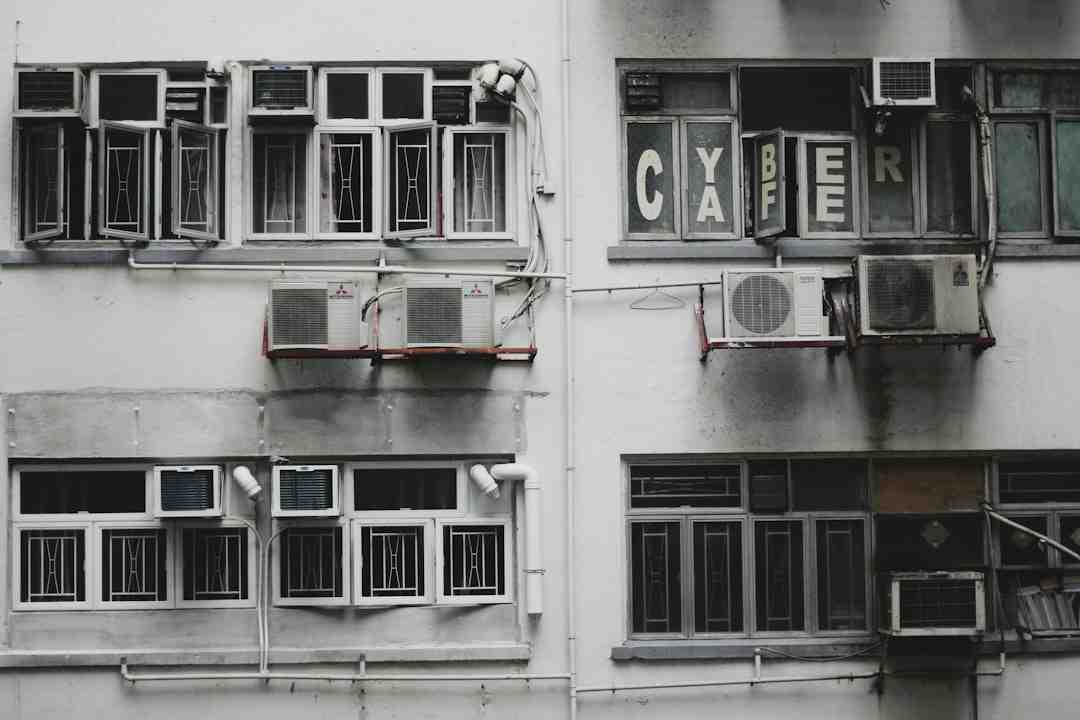 Old apartment building with multiple wall-mounted aircon units